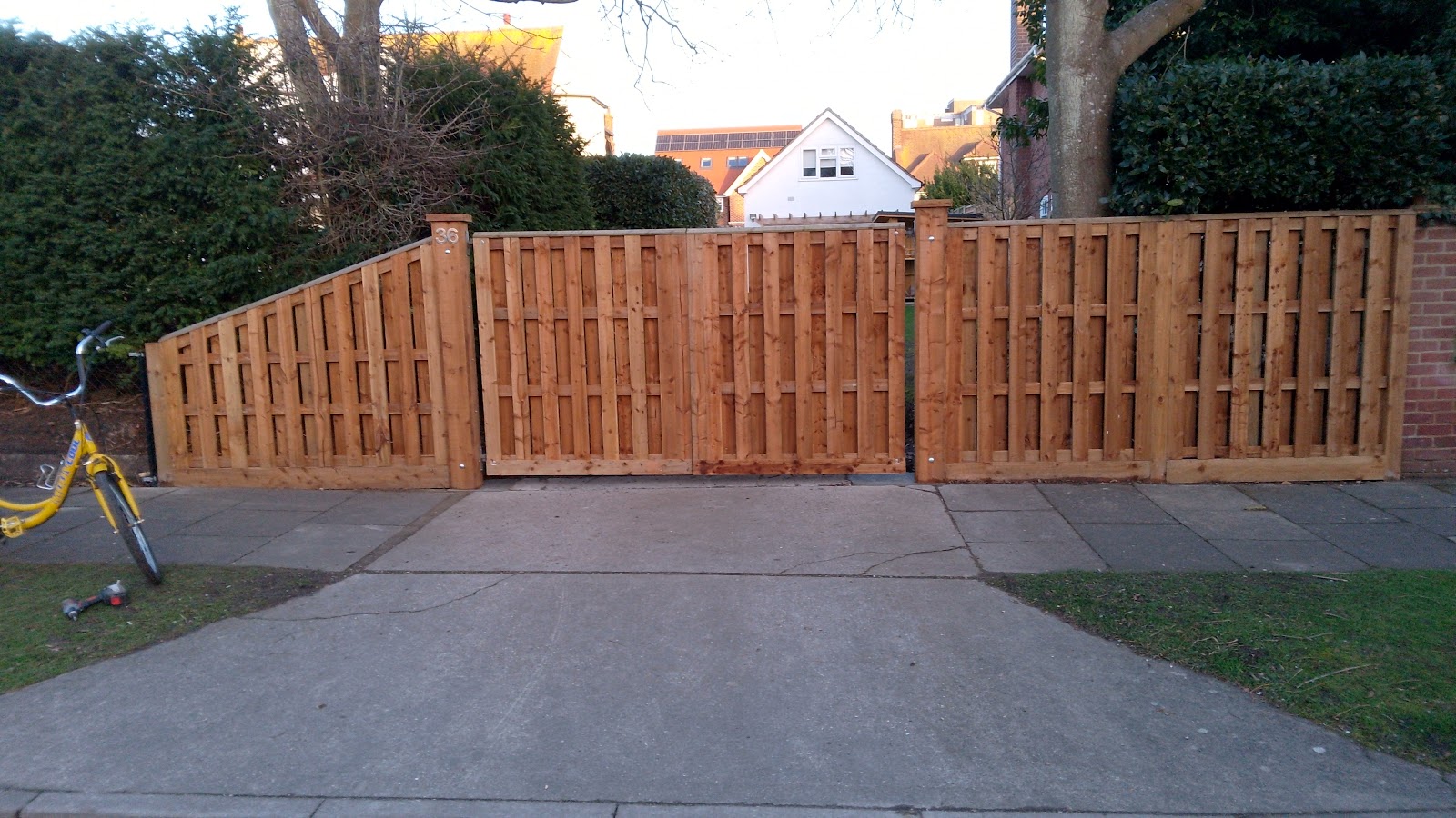 New timber gates and panel fencing across a driveway